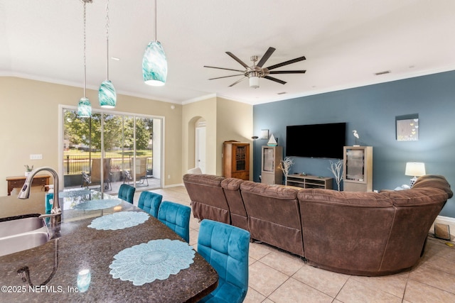 417 Palazzo Cir, Saint Augustine, FL 32092 - living area featuring light tile patterned flooring, arched walkways, ceiling fan, and ornamental molding