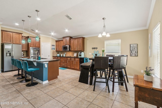 417 Palazzo Cir, Saint Augustine, FL 32092 - kitchen featuring appliances with stainless steel finishes, dark countertops, brown cabinetry, ornamental molding, and decorative backsplash