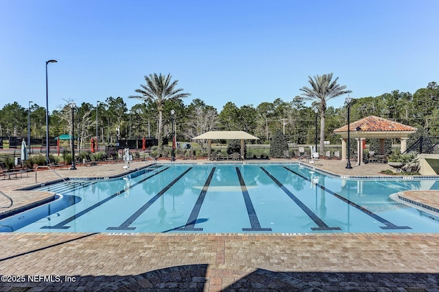 417 Palazzo Cir, Saint Augustine, FL 32092 - community pool featuring a gazebo, view of wooded area, and a patio area