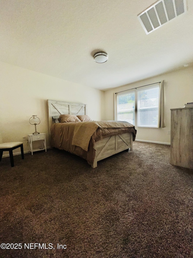 bedroom with baseboards, visible vents, and carpet floors