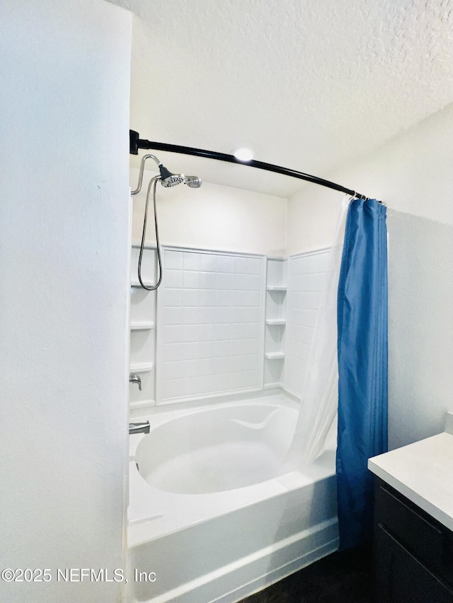 full bathroom with shower / bathtub combination with curtain, a textured ceiling, and vanity