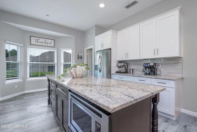 kitchen featuring visible vents, appliances with stainless steel finishes, and white cabinetry