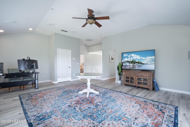 living area with wood finished floors, ceiling fan, and vaulted ceiling