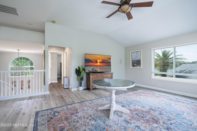 living room with wood finished floors, visible vents, a ceiling fan, and baseboards