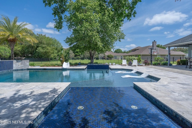 view of swimming pool with a patio, fence, and a fenced in pool