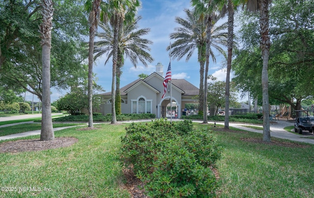 mediterranean / spanish house featuring a front lawn