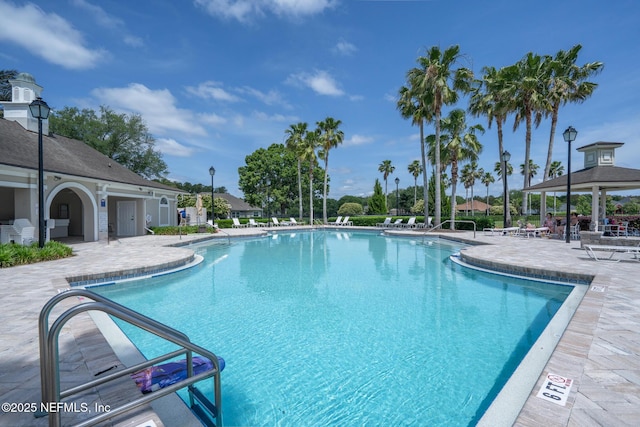 pool with a gazebo and a patio area