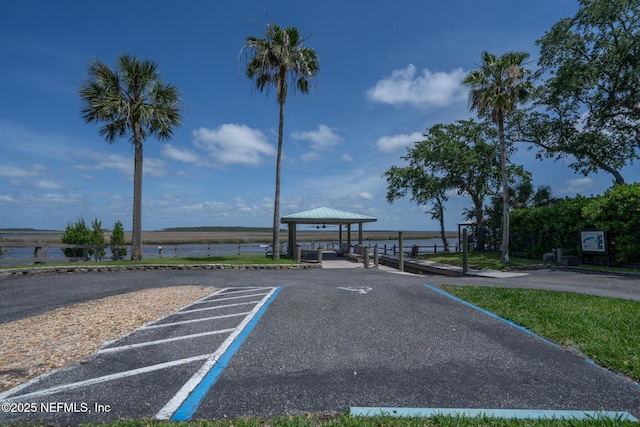 uncovered parking lot with a gazebo and a water view