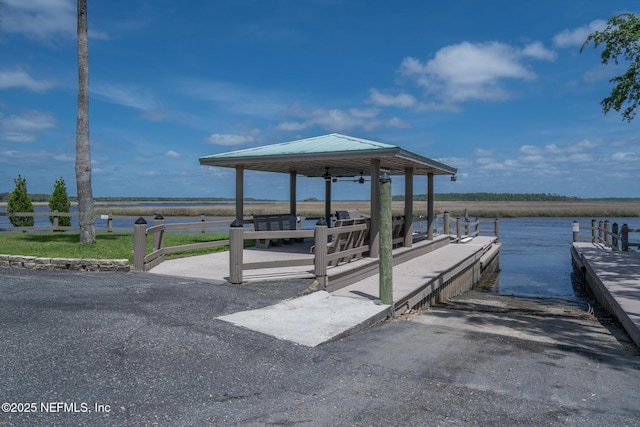 view of dock with a gazebo and a water view