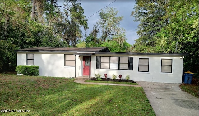 9717 Carbondale Dr W, Jacksonville, FL 32208 - single story home with stucco siding, a front yard, and concrete driveway