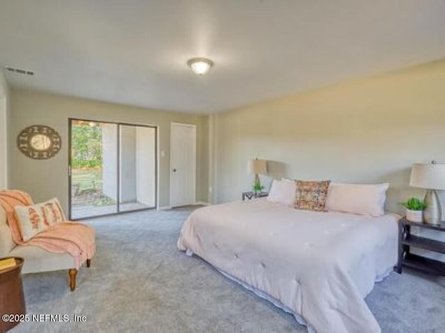 9717 Carbondale Dr W, Jacksonville, FL 32208 - carpeted bedroom featuring visible vents and access to outside