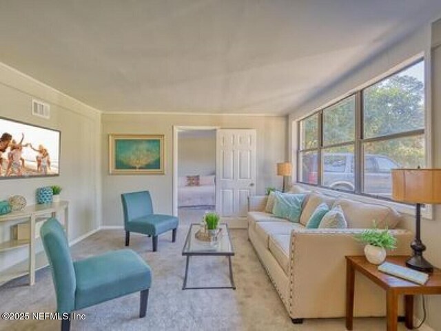 9717 Carbondale Dr W, Jacksonville, FL 32208 - living area featuring visible vents, light carpet, and baseboards