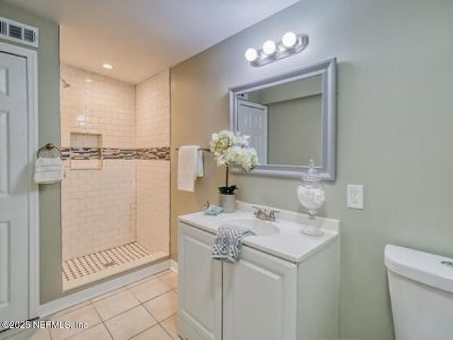 9717 Carbondale Dr W, Jacksonville, FL 32208 - bathroom with vanity, toilet, a stall shower, visible vents, and tile patterned flooring