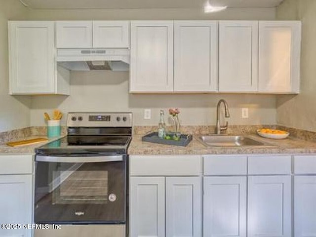9717 Carbondale Dr W, Jacksonville, FL 32208 - kitchen with a sink, electric stove, white cabinets, and under cabinet range hood