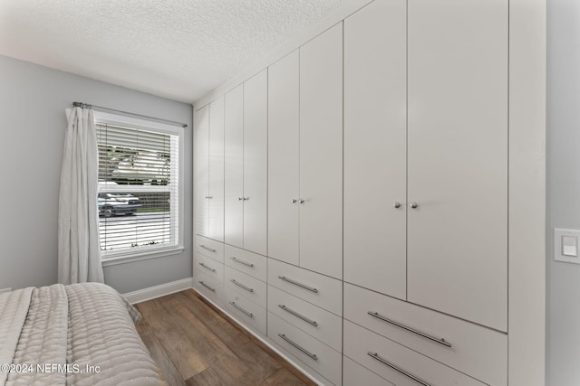 1246 Neck Rd, Ponte Vedra Beach, FL 32082 - bedroom featuring a textured ceiling, baseboards, and wood finished floors