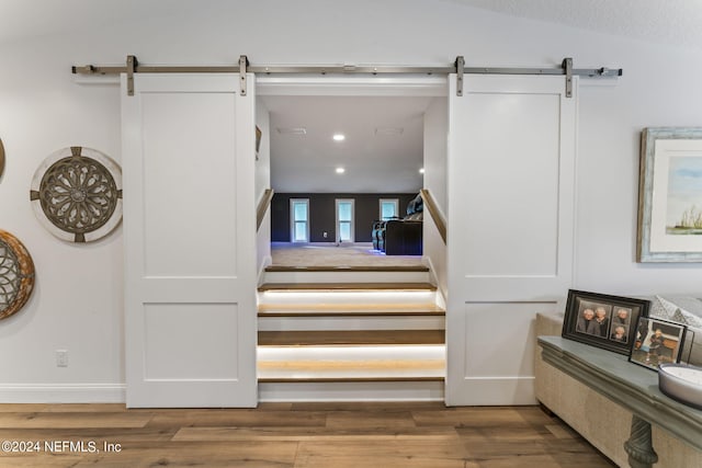 1246 Neck Rd, Ponte Vedra Beach, FL 32082 - staircase featuring wood finished floors, a barn door, baseboards, lofted ceiling, and recessed lighting