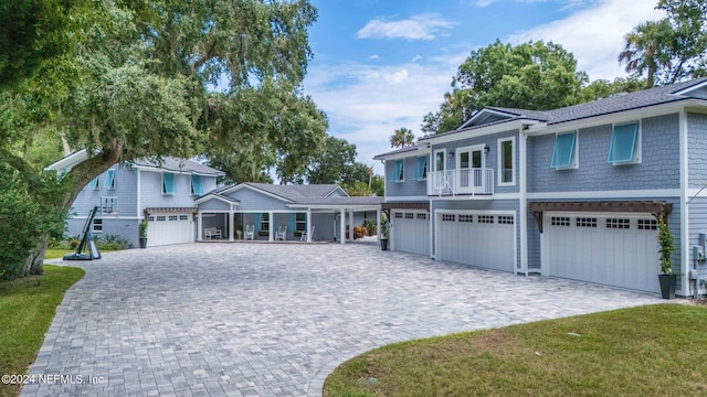 1246 Neck Rd, Ponte Vedra Beach, FL 32082 - view of front facade with decorative driveway, an attached garage, and a balcony
