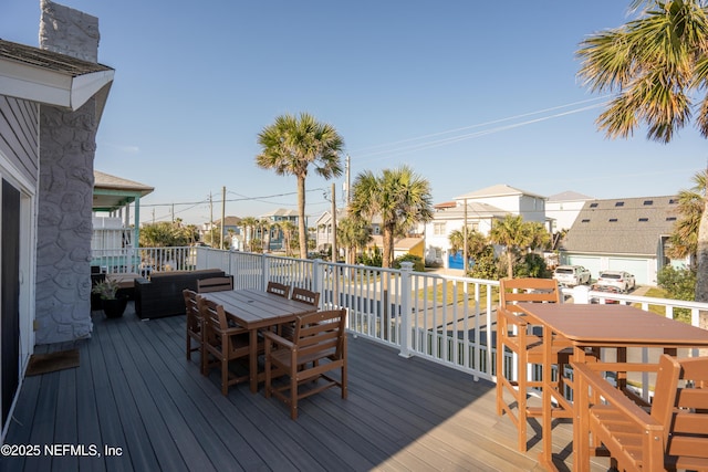 deck with outdoor lounge area, a residential view, and outdoor dining area