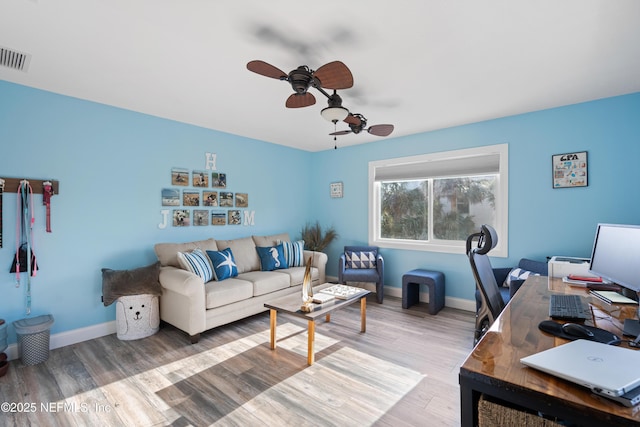 office area featuring visible vents, light wood-type flooring, a ceiling fan, and baseboards