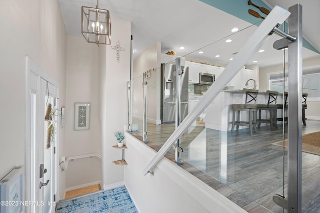 entryway featuring recessed lighting, a chandelier, and baseboards