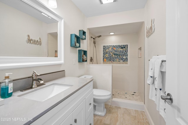 bathroom with vanity, toilet, and a stall shower