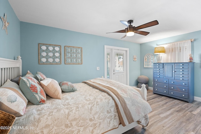 bedroom featuring wood finished floors, ceiling fan, and baseboards
