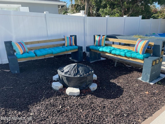 view of yard with an outdoor fire pit and fence
