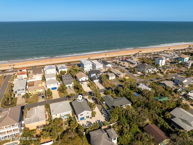 bird's eye view featuring a beach view, a water view, and a residential view