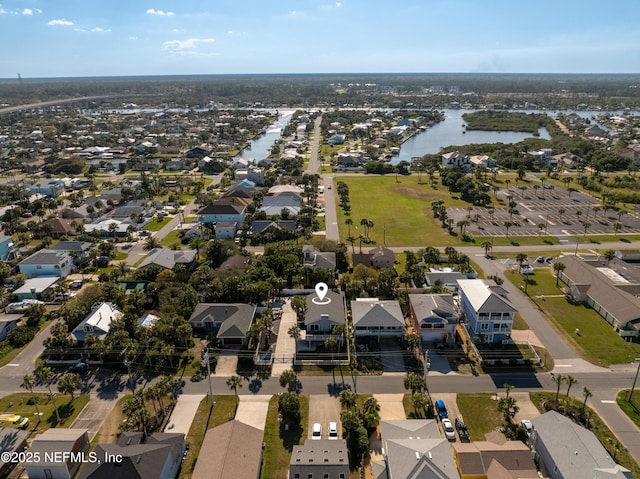 drone / aerial view featuring a residential view and a water view