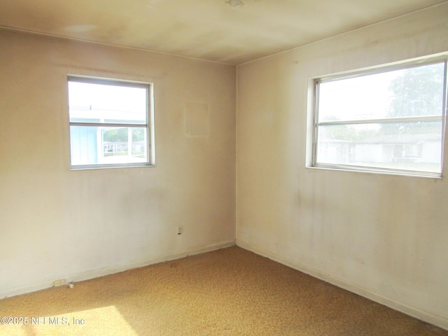 empty room featuring carpet floors and a healthy amount of sunlight