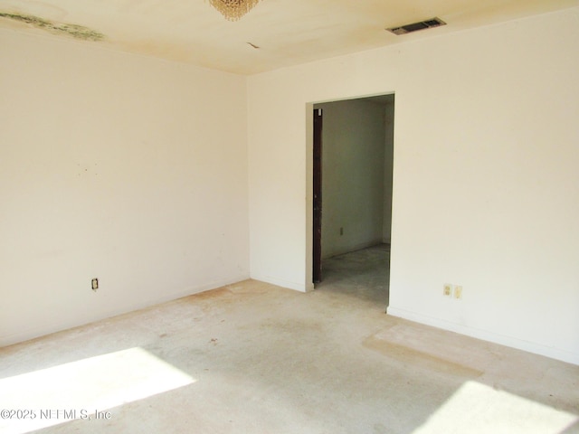 unfurnished room with visible vents and light colored carpet