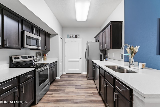 4958 Key Lime Dr Unit 106, Jacksonville, FL 32256 - kitchen with light countertops, a sink, appliances with stainless steel finishes, and light wood-style floors