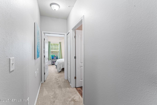 4958 Key Lime Dr Unit 106, Jacksonville, FL 32256 - corridor featuring light colored carpet, a textured wall, and baseboards