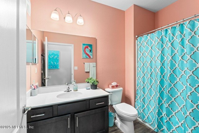 4958 Key Lime Dr Unit 106, Jacksonville, FL 32256 - full bath featuring wood finished floors, toilet, a shower with shower curtain, and vanity