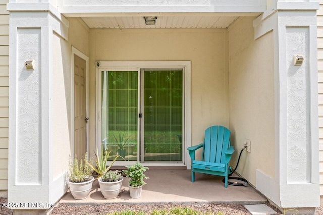 4958 Key Lime Dr Unit 106, Jacksonville, FL 32256 - entrance to property featuring a patio and stucco siding