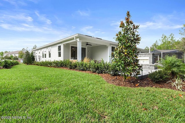 view of property exterior with a ceiling fan, a yard, and a garage