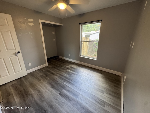 6070 Baltimore Ave, Cocoa, FL 32927 - unfurnished bedroom featuring dark wood-style floors, baseboards, and ceiling fan