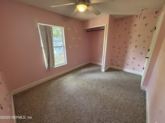 6070 Baltimore Ave, Cocoa, FL 32927 - unfurnished bedroom featuring a textured ceiling, carpet floors, baseboards, a closet, and a ceiling fan