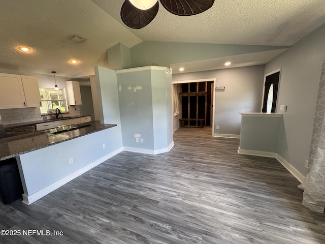6070 Baltimore Ave, Cocoa, FL 32927 - kitchen featuring vaulted ceiling, white cabinetry, a textured ceiling, dark wood finished floors, and ceiling fan