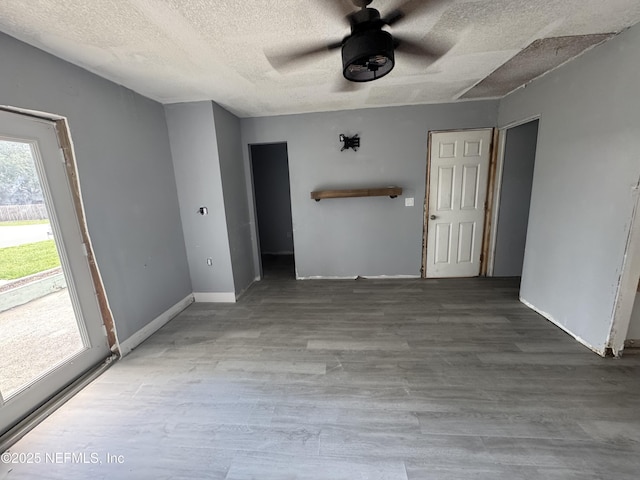 6070 Baltimore Ave, Cocoa, FL 32927 - empty room with a textured ceiling, a ceiling fan, wood finished floors, and baseboards