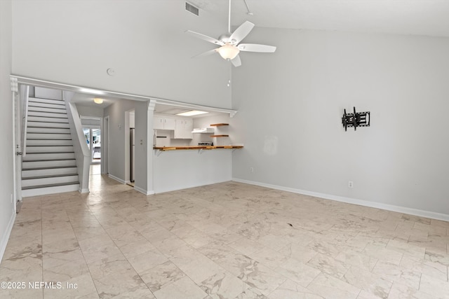 1616 1st St, Neptune Beach, FL 32266 - unfurnished living room with a ceiling fan, stairway, and baseboards