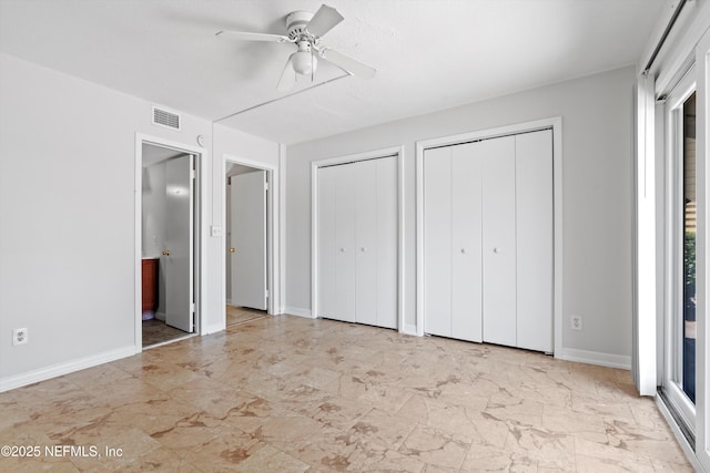 1616 1st St, Neptune Beach, FL 32266 - unfurnished bedroom with multiple closets, baseboards, ensuite bathroom, and ceiling fan