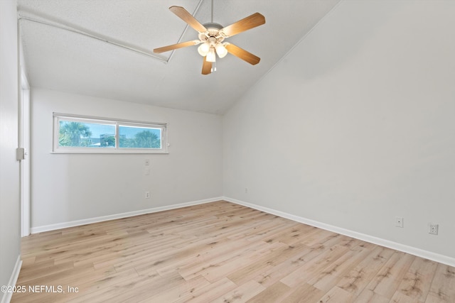 1616 1st St, Neptune Beach, FL 32266 - spare room with light wood-style flooring, ceiling fan, vaulted ceiling, and baseboards