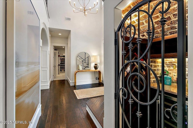 301 S Roscoe Blvd, Ponte Vedra Beach, FL 32082 - interior space featuring visible vents, baseboards, a chandelier, a high ceiling, and hardwood / wood-style floors