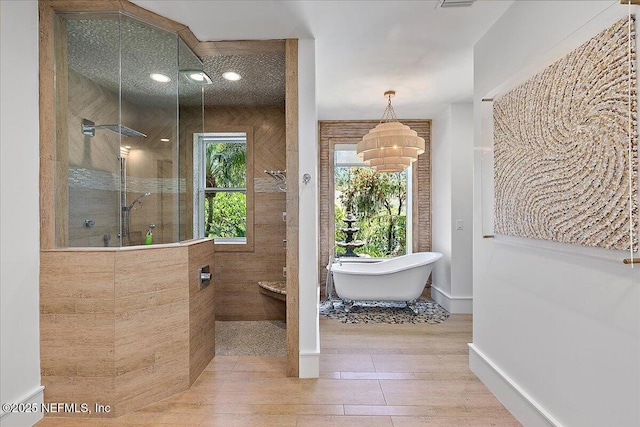 301 S Roscoe Blvd, Ponte Vedra Beach, FL 32082 - bathroom with a chandelier, a freestanding tub, walk in shower, and wood finished floors