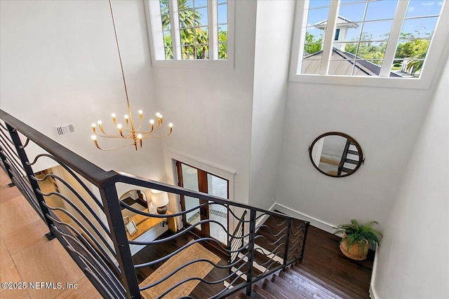 301 S Roscoe Blvd, Ponte Vedra Beach, FL 32082 - staircase featuring visible vents, wood finished floors, and a notable chandelier