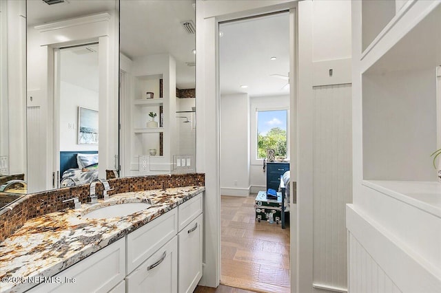 301 S Roscoe Blvd, Ponte Vedra Beach, FL 32082 - ensuite bathroom featuring vanity, connected bathroom, visible vents, and built in shelves