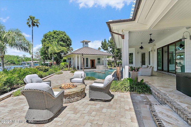 301 S Roscoe Blvd, Ponte Vedra Beach, FL 32082 - view of patio / terrace with a storage structure, an outdoor structure, a pool with connected hot tub, and an outdoor fire pit