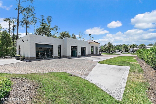 301 S Roscoe Blvd, Ponte Vedra Beach, FL 32082 - exterior space with stucco siding, decorative driveway, an attached garage, and a front lawn
