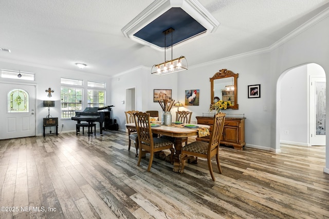 1417 Marlee Rd, Saint Johns, FL 32259 - dining room featuring arched walkways, crown molding, light wood finished floors, baseboards, and a chandelier